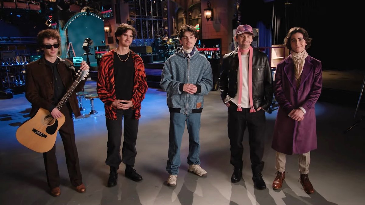 Four people who vaguely look like Timothée Chalamet stand around him in a promo for SNL