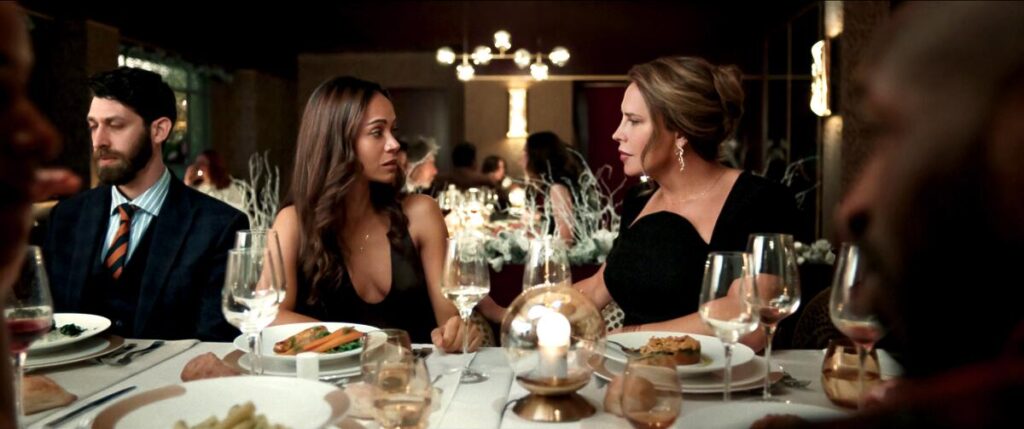 Two women talk at a table at a banquet hall