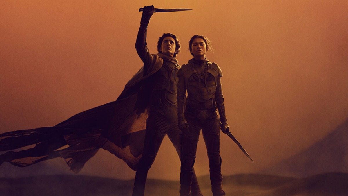 Paul Atreides holding up a dagger standing next to Chani in Dune: Part Two