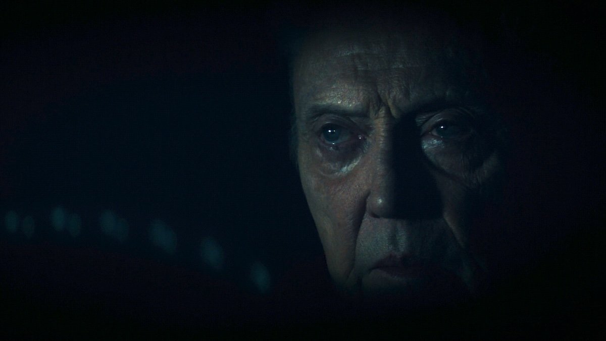 Christopher Walken behind the wheel in the shadows on Severance