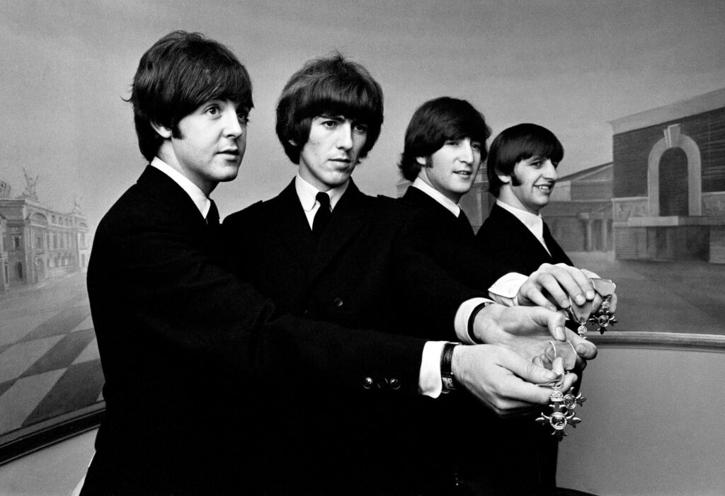 The Beatles show off their MBE medals after the royal investiture at Buckingham Palace, London, Tuesday 26th October 1965.