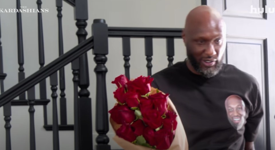 Lamar Odom holding red roses on The Kardashians.