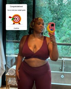 Lizzo in workout clothes, celebrating weight loss goals.