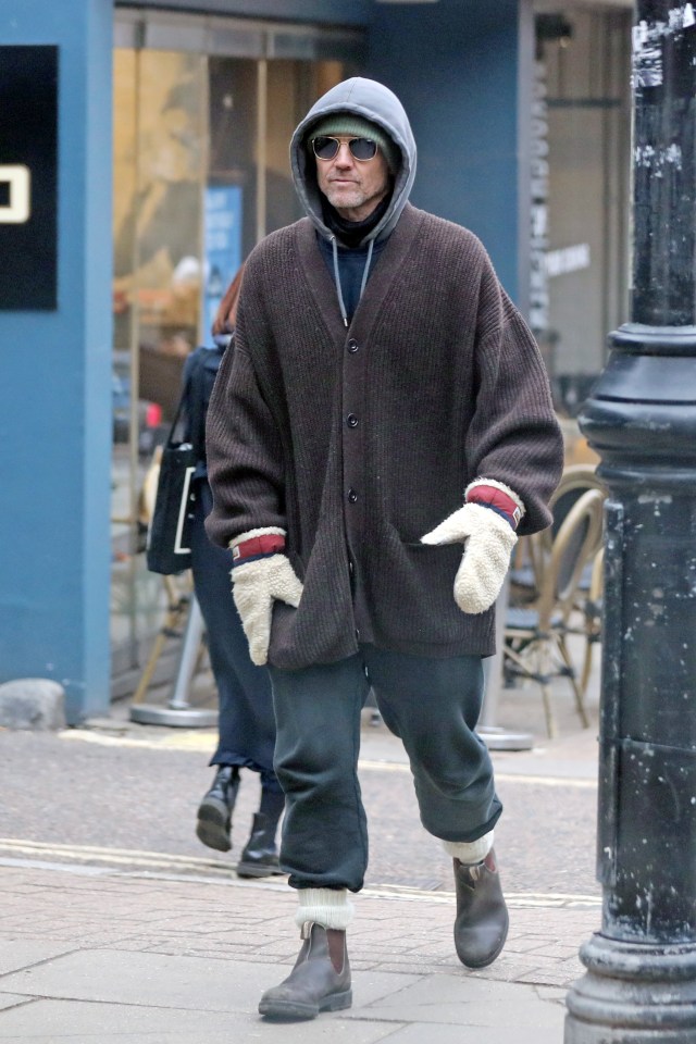 Jason Orange walking down a street.