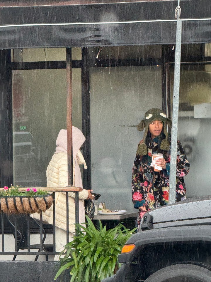 Jada Pinkett Smith and Willow Smith having lunch outdoors in the rain.