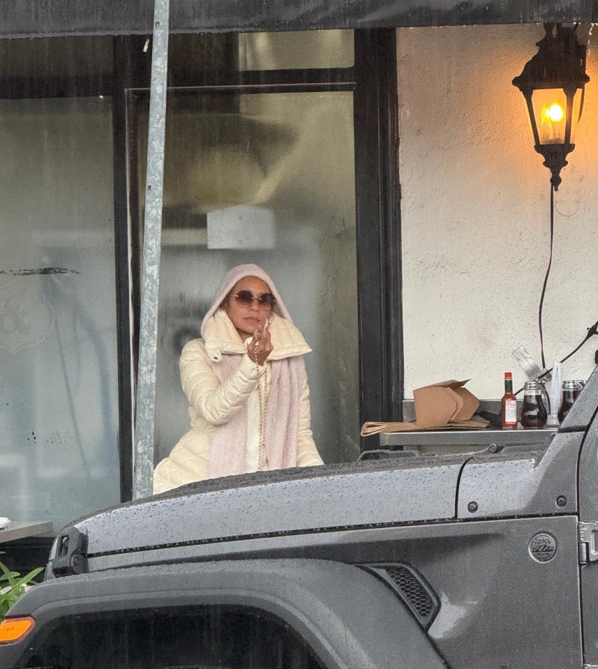 Jada Pinkett Smith giving the finger while sitting in a car.