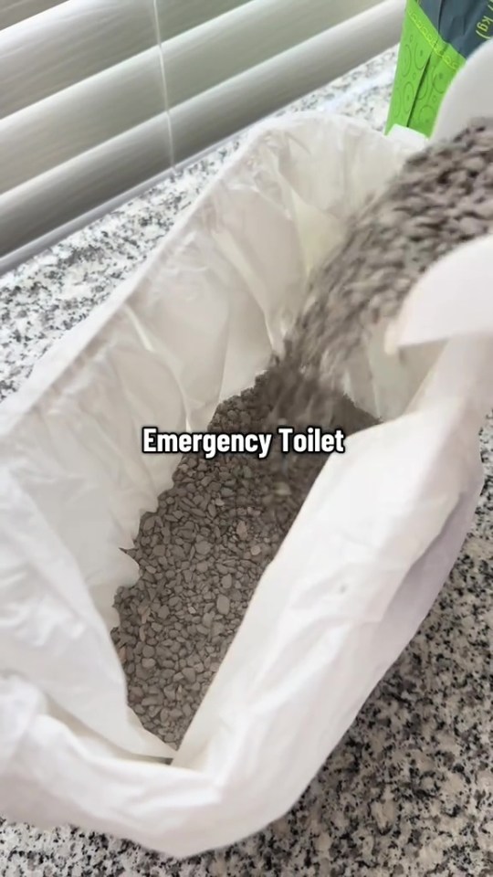 Emergency toilet being filled with gray pellets.