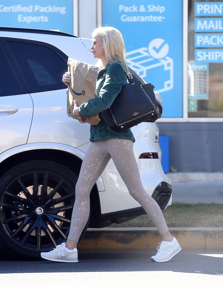 Brooke Burns carrying an Amazon package.