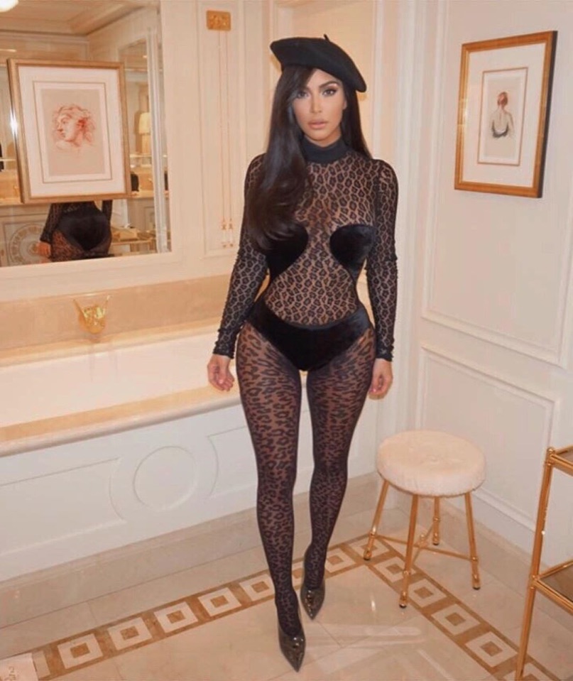 Kim Kardashian wearing a leopard-print bodysuit and tights.