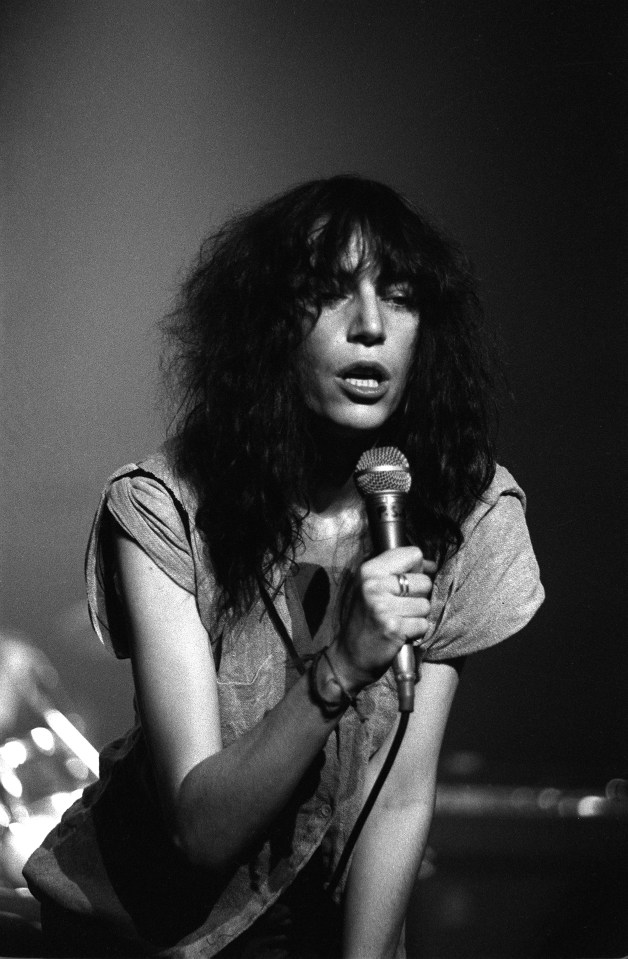 Black and white photo of Patti Smith performing live at the Apollo.