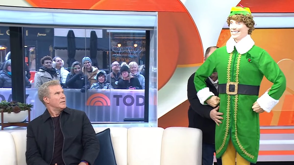 Will Ferrell sitting on the TODAY show couch looks up at a creepy Buddy the Elf Animatronic