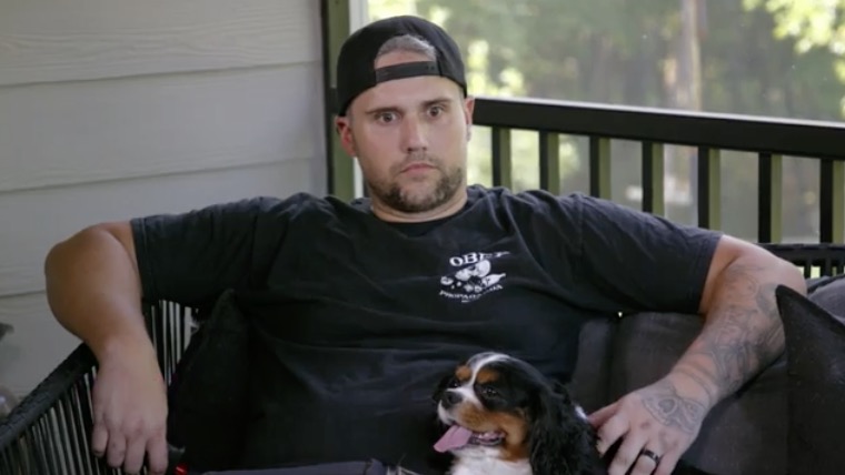 Ryan Edwards sitting outside with his dog.