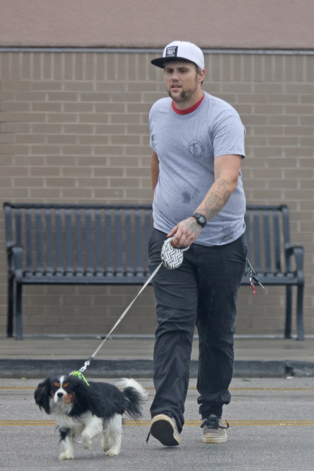 Ryan Edwards walking a dog.