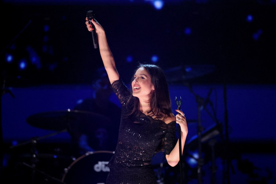 Olivia Rodrigo performing at a concert.