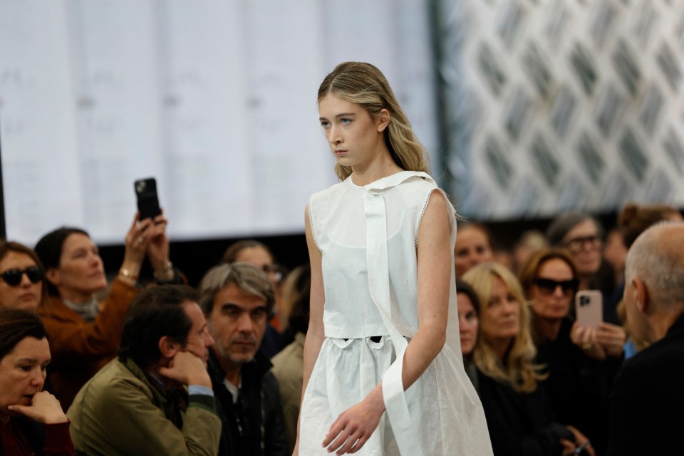 Model in white dress at Paris Fashion Week.