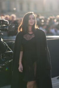 Ana de Armas wears a black coat, a black dress in transparent lace, outside Louis Vuitton