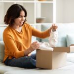 disappointed woman opening box of shoes