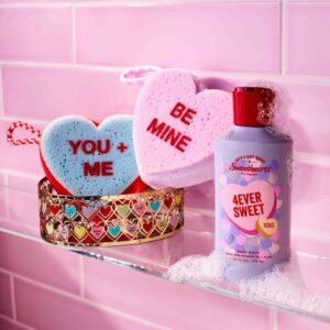 Bu200bath & Body Works bath products in the Valentine's Day scent u201c4Ever Sweetu201d on a shower ledge against pink tiles