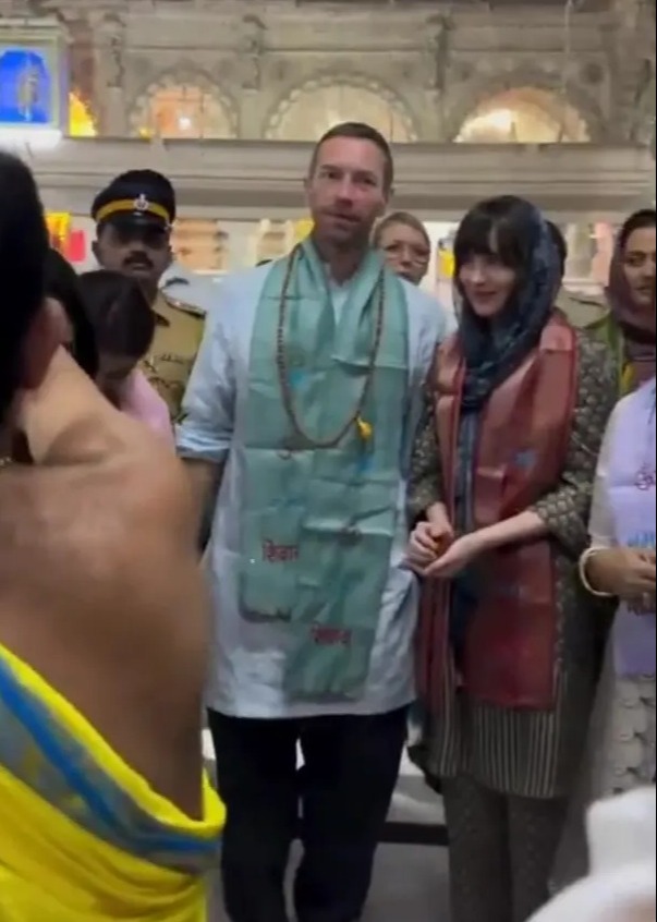 Chris Martin and Dakota Johnson at a temple.