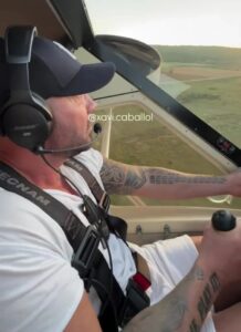 Man piloting an ultralight aircraft.