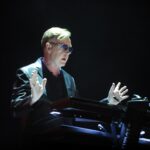 Andrew Fletcher, keyboardist for Depeche Mode, playing a keyboard.