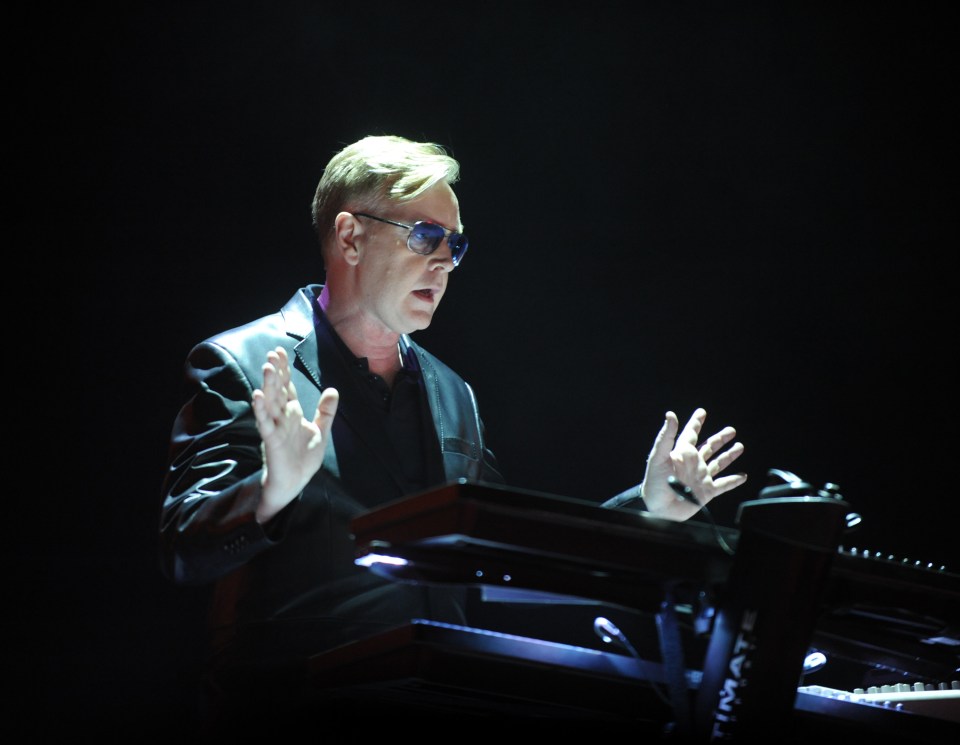 Andrew Fletcher, keyboardist for Depeche Mode, playing a keyboard.