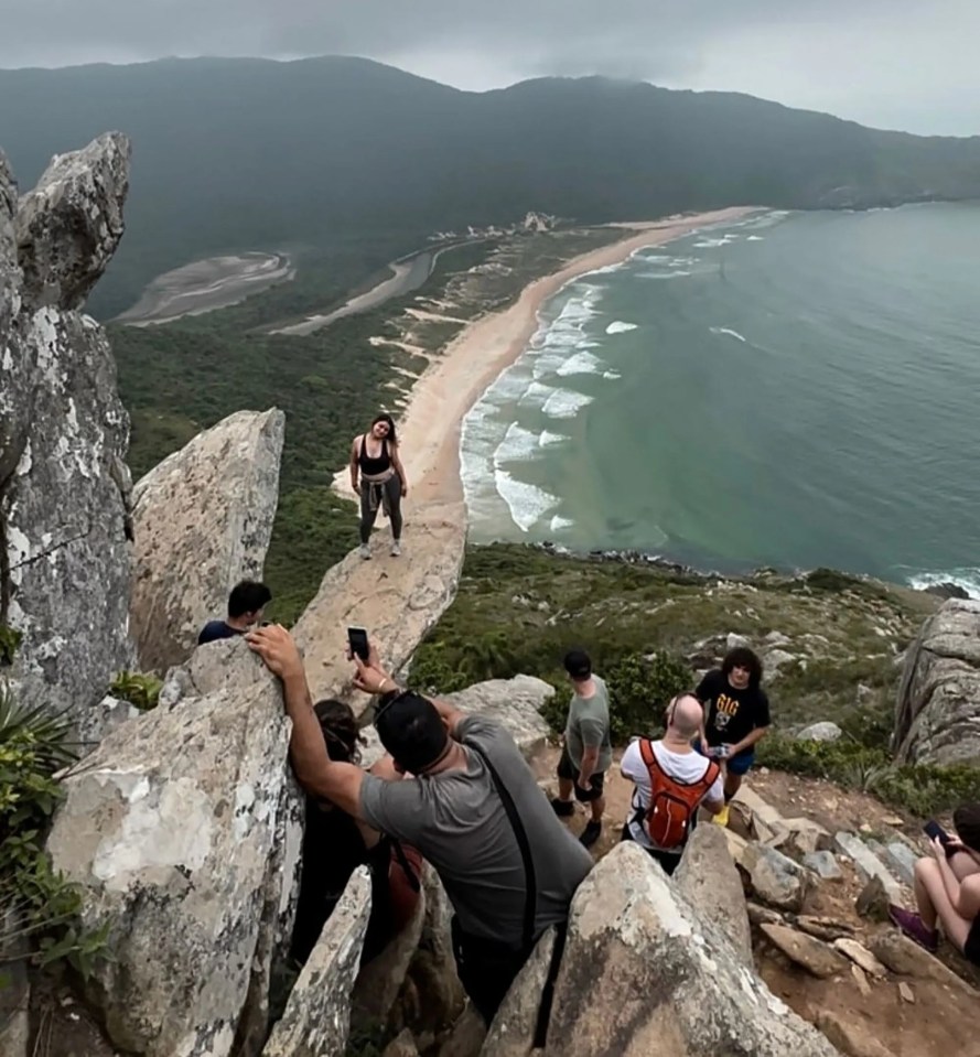 Influencers and tourists are seen at Pedra do Surfista (Surfer's Rock) near Florianopolis, Brazil