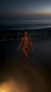 Kim Kardashian stripped off to a tiger print bikini for a dip in the ocean