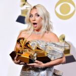 Lady Gaga holding Grammy Awards.