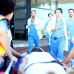 Doctors and nurses rushing to patient on ambulance stretcher