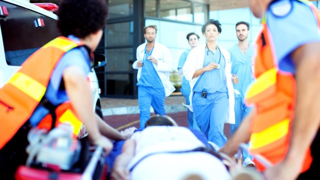 Doctors and nurses rushing to patient on ambulance stretcher