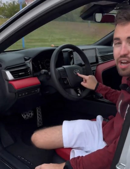 Man reviewing a Toyota Camry's interior.