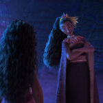 A tall woman with long dark hair in a high ponytail looks at Moana, with her arms crossed over her chest