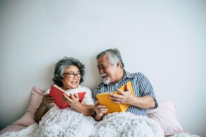 A senior couple reading in bed