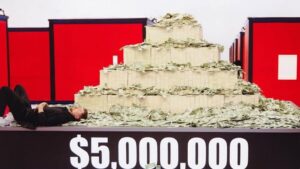 MrBeast posing with the grand prize of $5M.