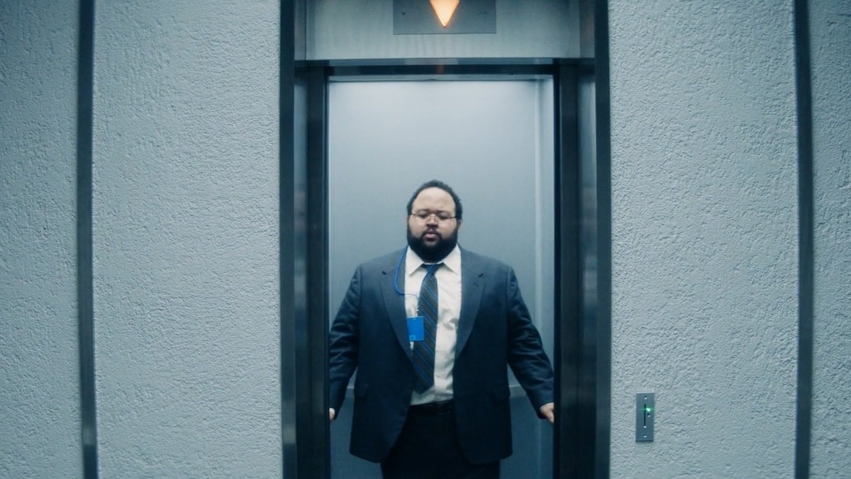 Dylan in an open elevator on Severance