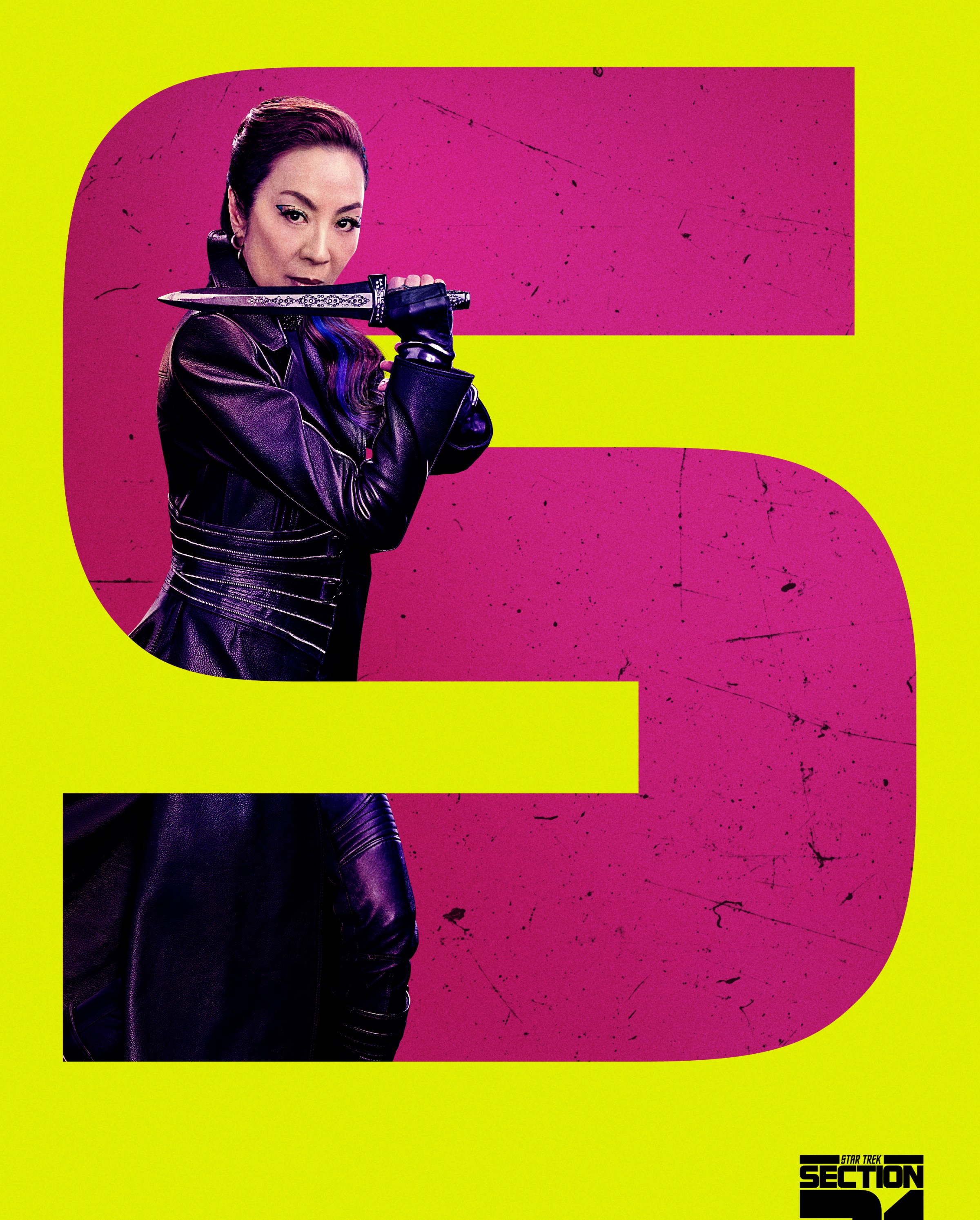 Michele Yeoh poses as Philippa Georgiou in a leather duster with a dagger inside a large graphic ‘S’ for ‘Section 31’ on a poster for the movie of the same name.