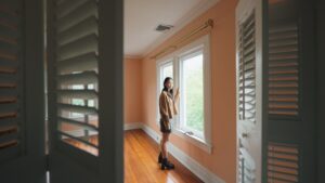 Chloe (Callina Liang), a forlorn-looking teenager, stands by a window in an unfurnished room and looks at the closet, where an unseen presence lurks in Presence