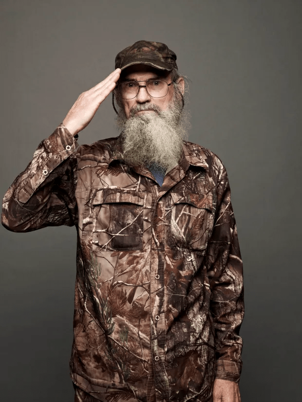 Man in camouflage saluting.