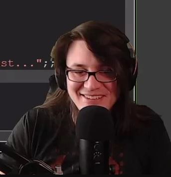 Streamer smiling while using a microphone.