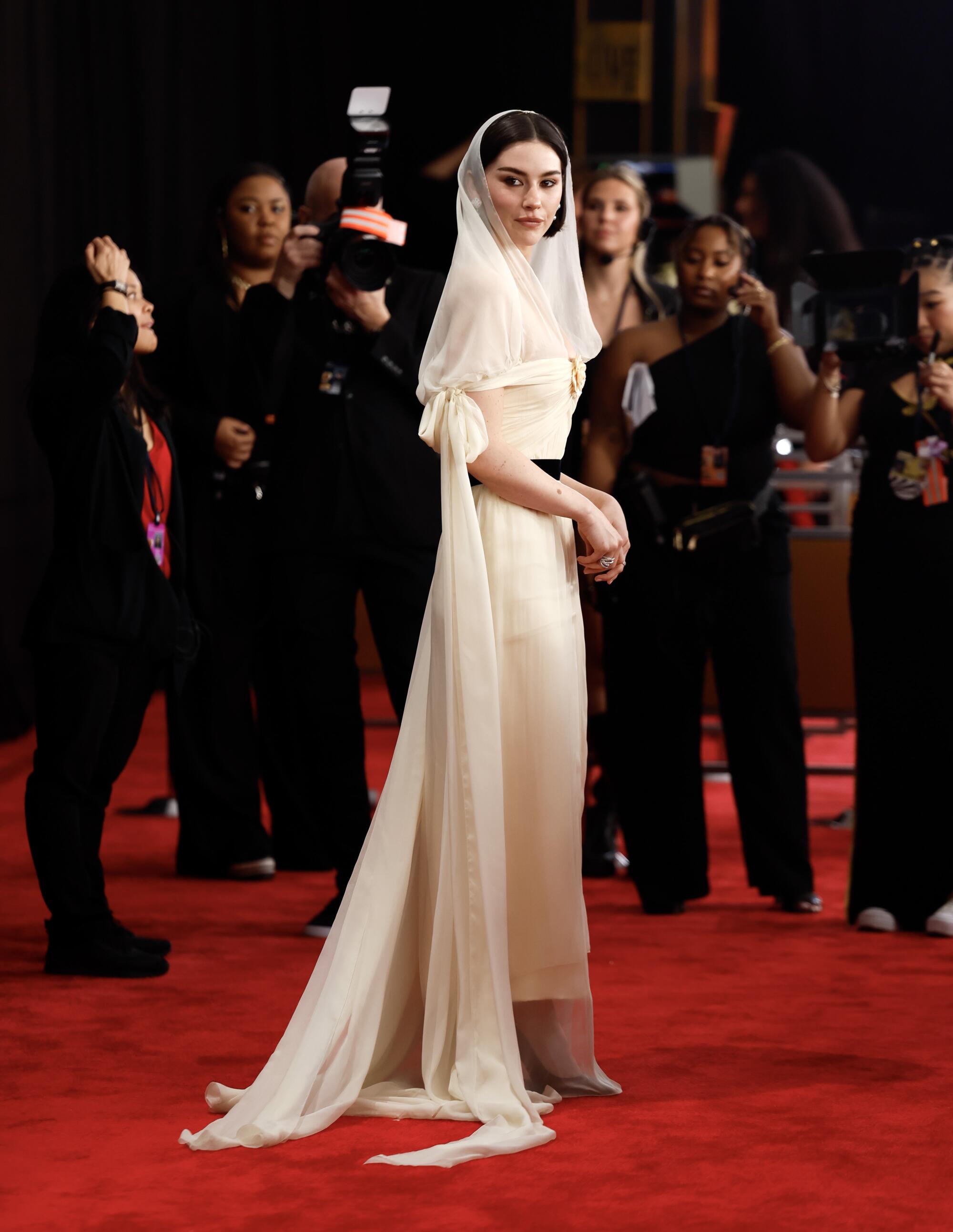 Gracie Abrams in pale gown with veil 