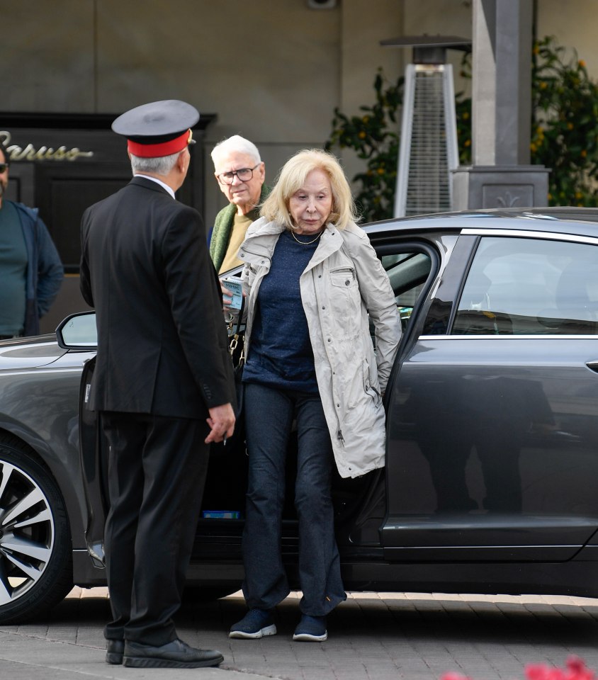 Michael Learned exiting a car with her husband.