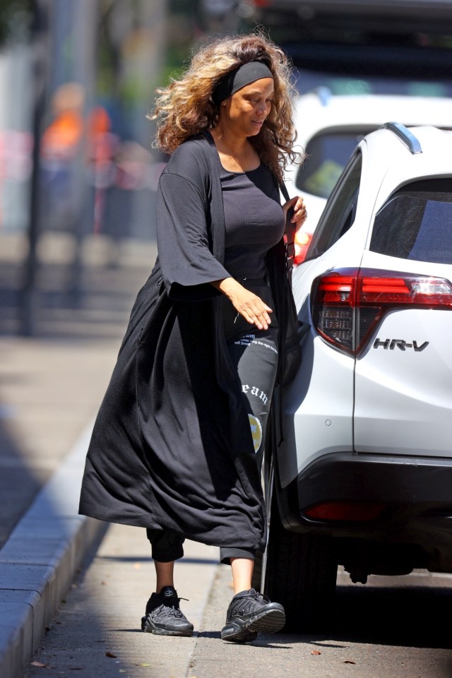 Tyra Banks walking near a car.