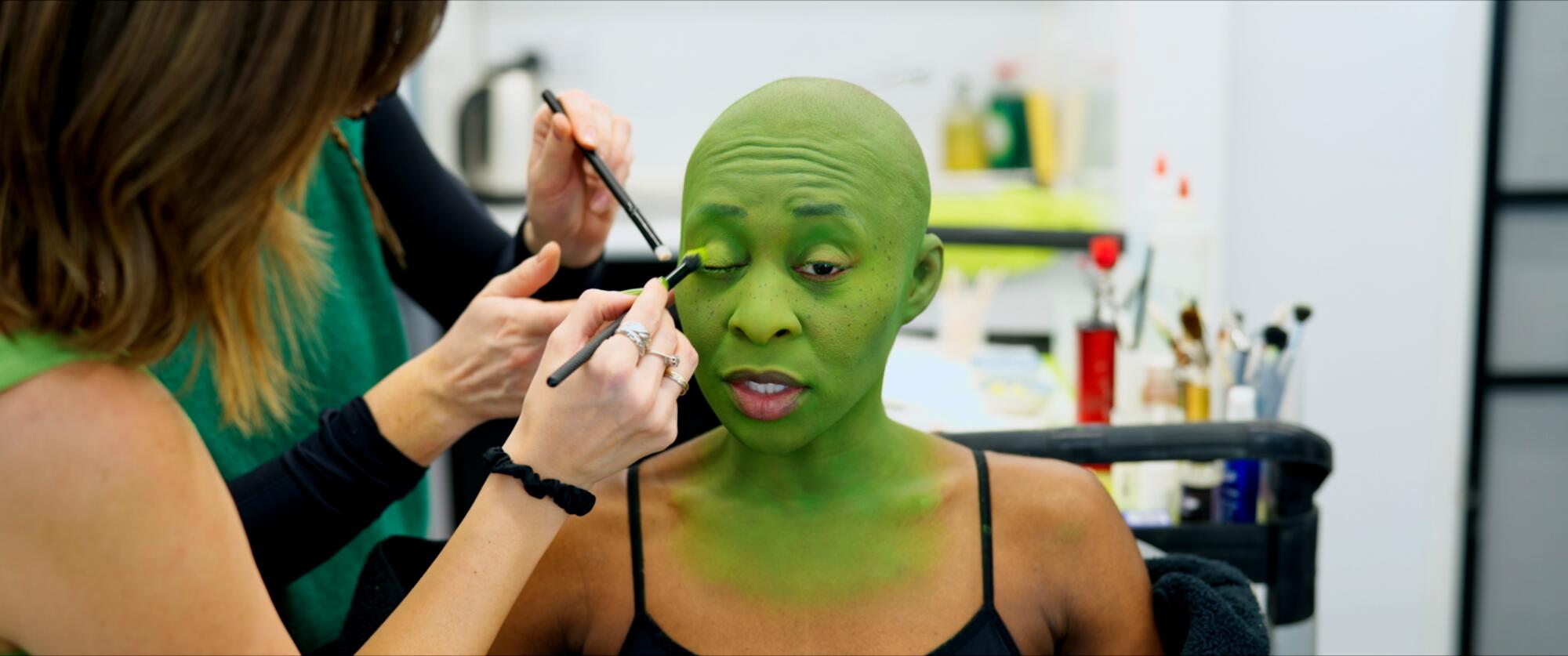 Cynthia Erivo has green makeup applied to her skin for her role as witch Elphaba in “Wicked.”