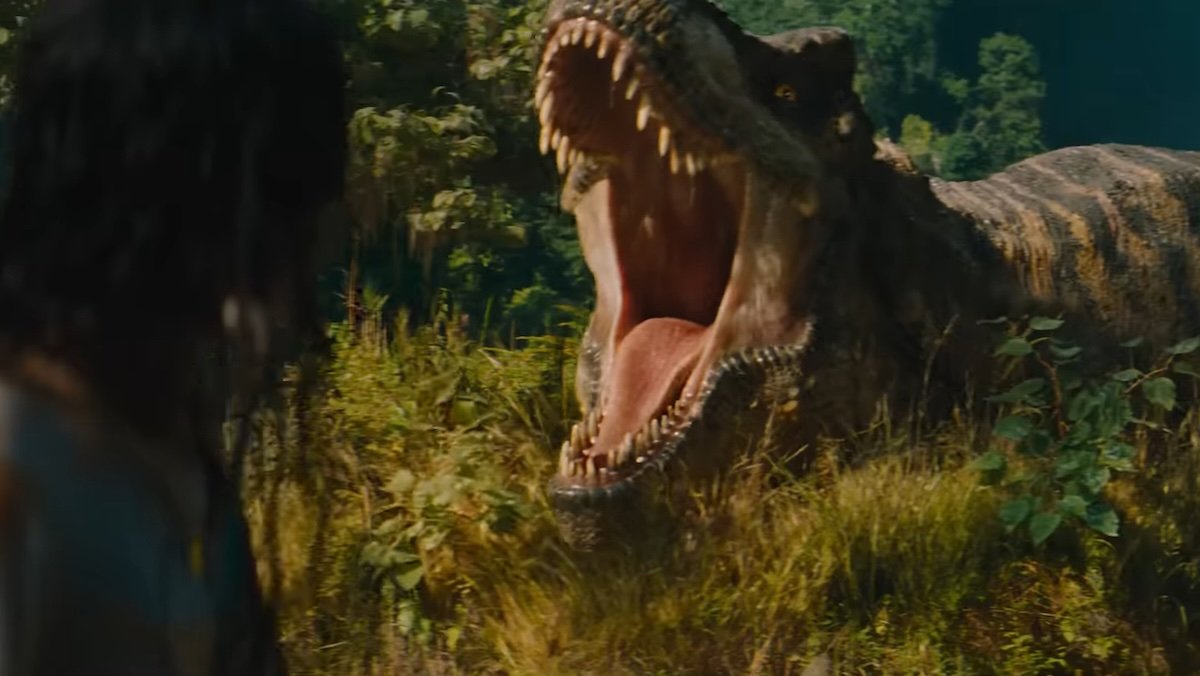 A T.Rex roars with a woman facing it in the foreground in Jurassic World Rebirth