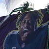 Workers hang player banners outside the Caesars Superdome on Saturday in New Orleans, ahead of the Super Bowl between the Philadelphia Eagles and the Kansas City Chiefs.