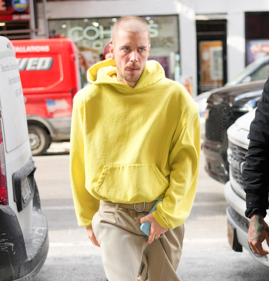 Justin Bieber wearing a yellow hoodie.