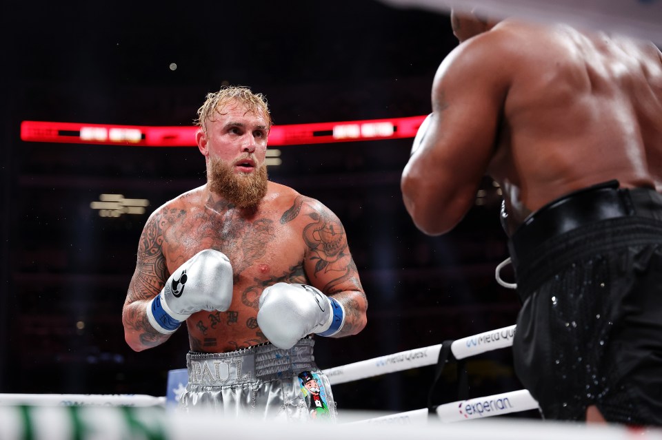 Jake Paul facing Mike Tyson in a boxing match.