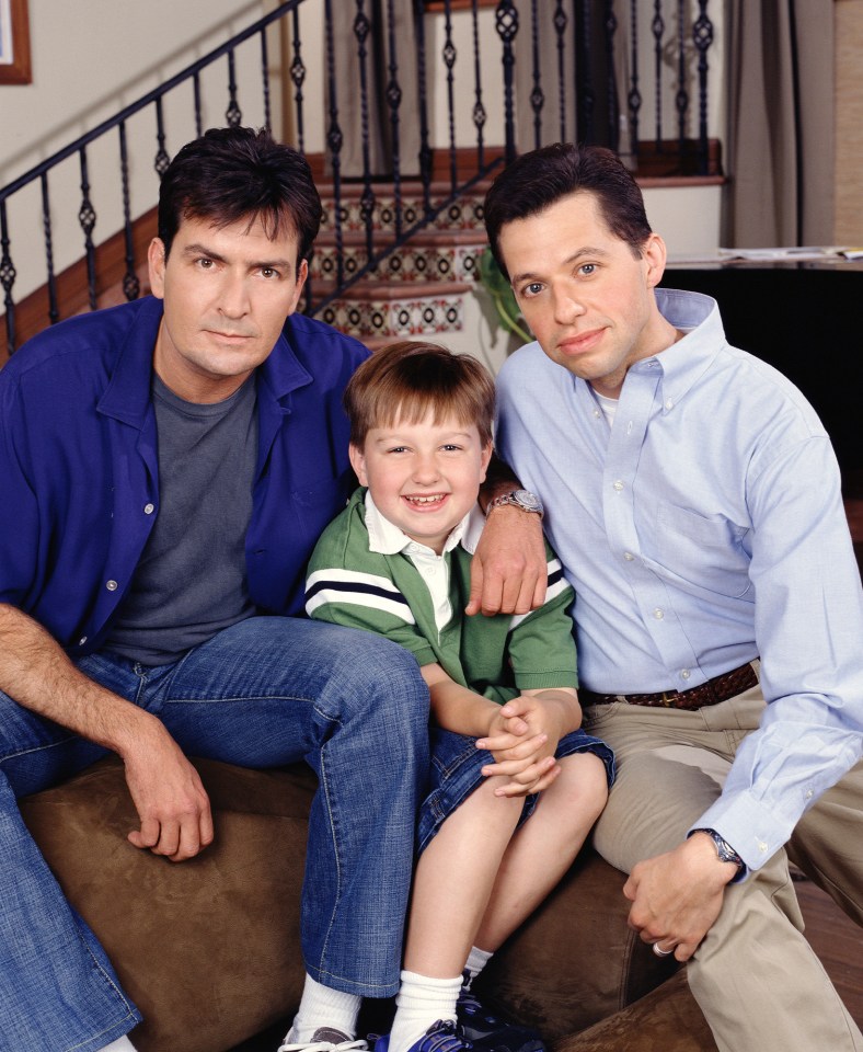 Promotional photo of Charlie Sheen, Angus T. Jones, and Jon Cryer from *Two and a Half Men*.