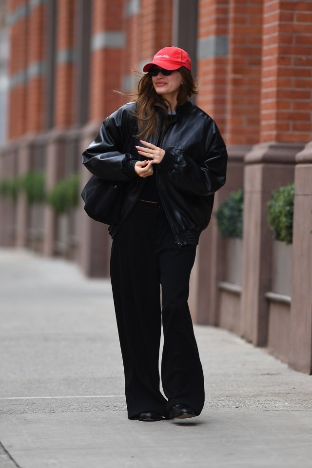 Hailey Bieber walking down a city street in New York City.